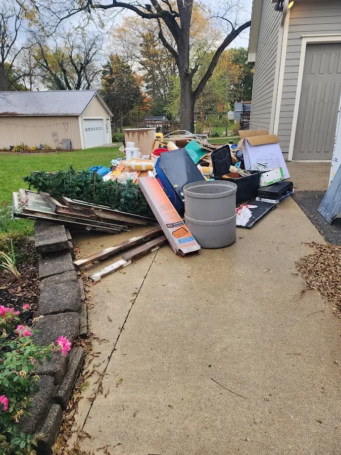 Dumpster being loaded with debris for Estate Cleanout Dumpster Rental in SeaTac